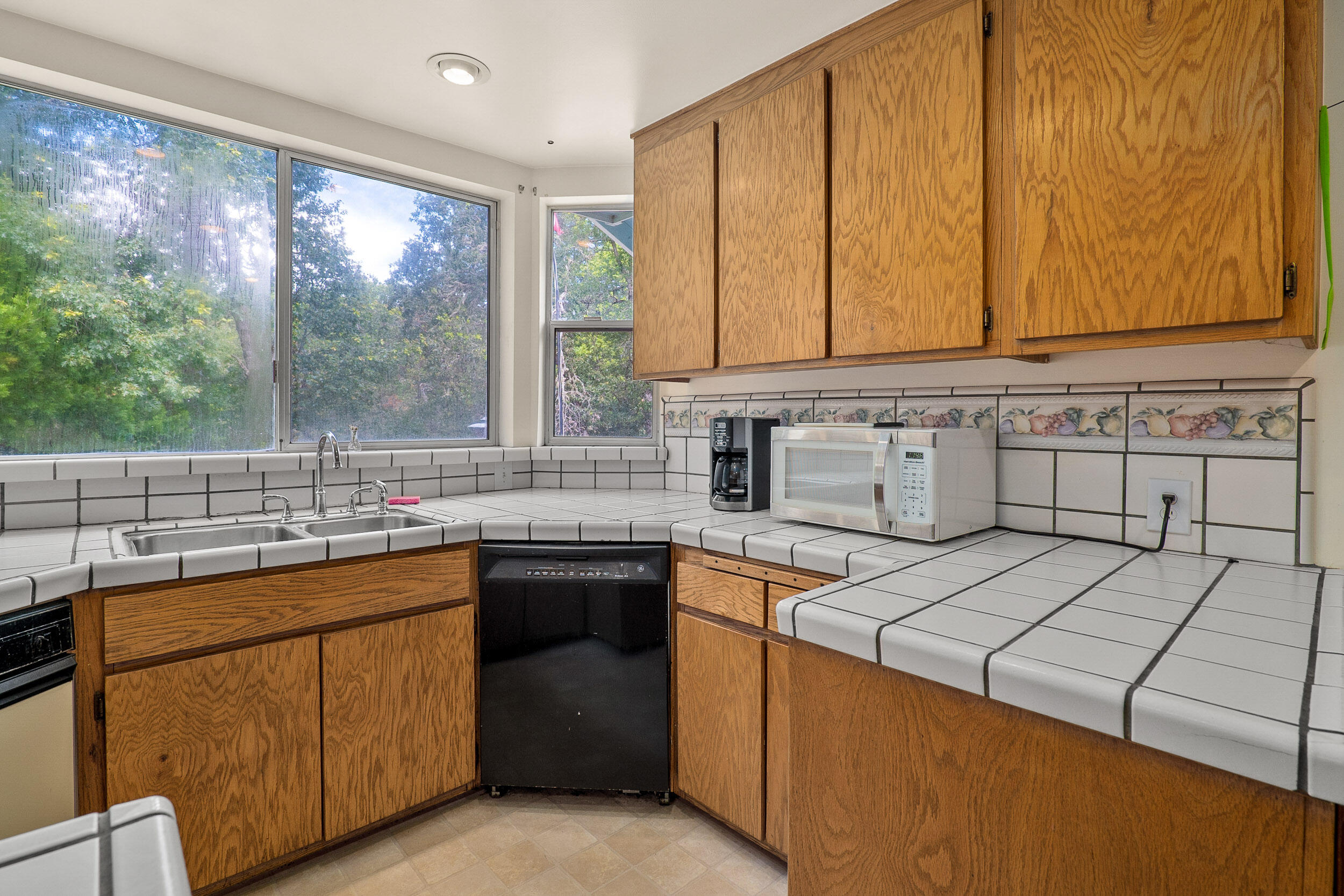 6801 Tunnel Loop Road Grants Pass, OR 97526 - Photo 13 of 40 a kitchen with a sink stove and cabinets