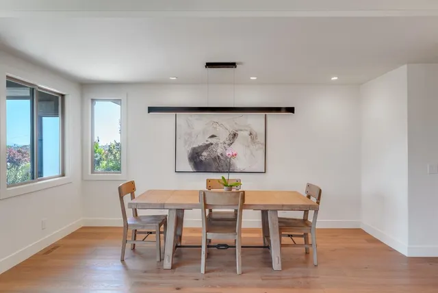a view of a dining room with furniture and wooden floor