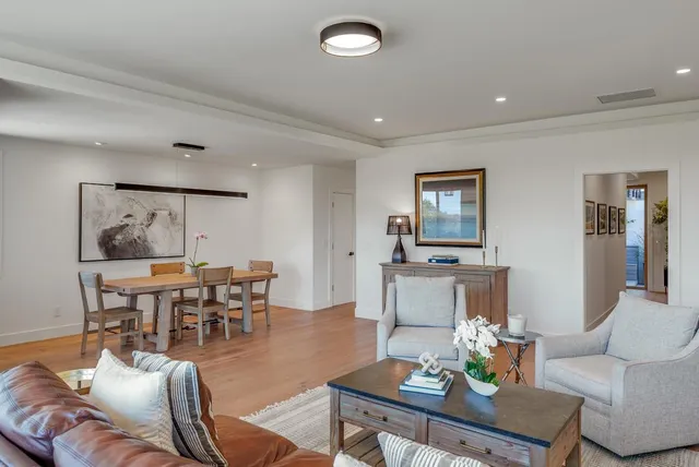 a living room with furniture and a dining table