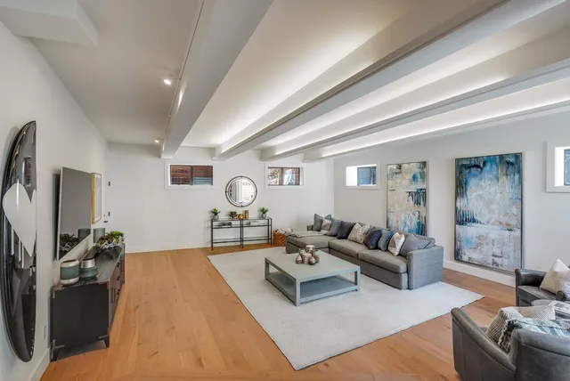 a living room with furniture a table and a flat screen tv