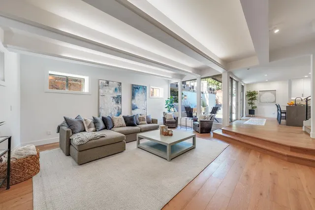 a living room with fireplace furniture and a large window