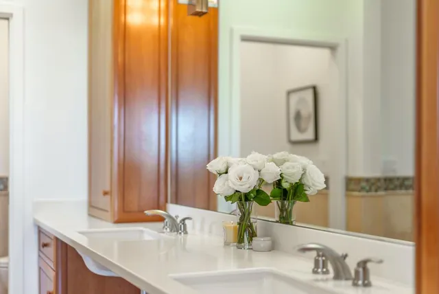 a bathroom with a sink vanity and a mirror
