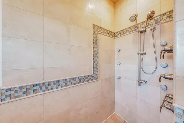 a bathroom with a shower and a mirror