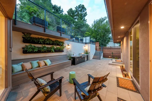 a view of a patio with couple of chairs