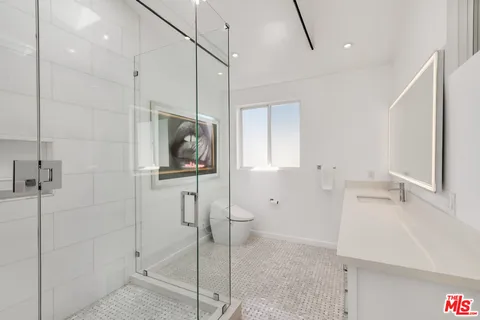 a spacious bathroom with a tub shower sink and mirror