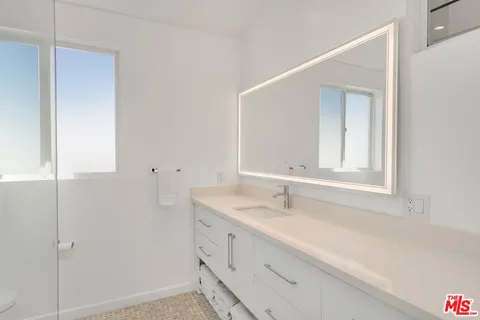 a bedroom with a bed and a desk