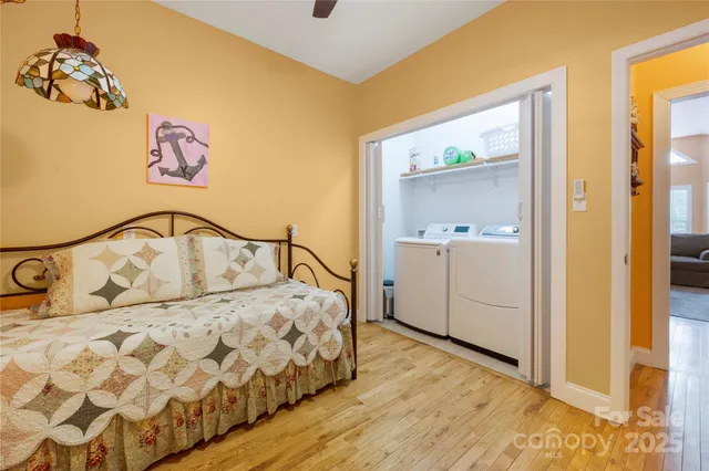 a bedroom with a bed and a painting on the wall