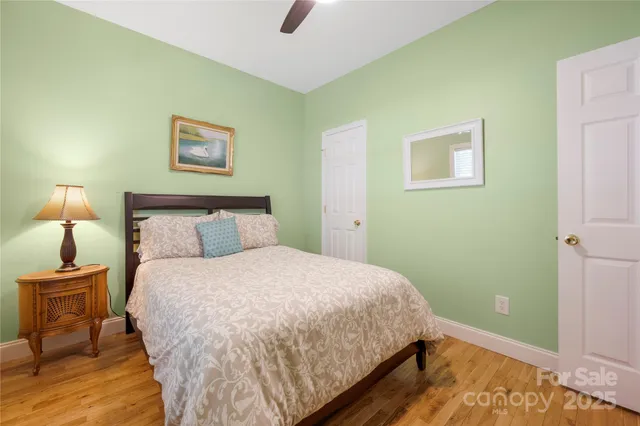 a bedroom with a bed and a lamp