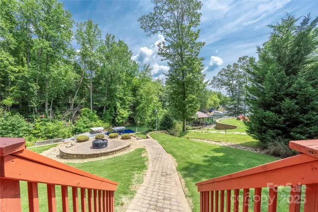 a view of a swimming pool and lounge chairs in the patio