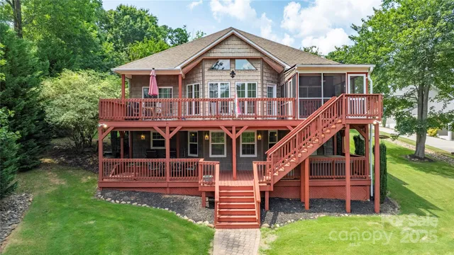 a view of house with a yard and balcony