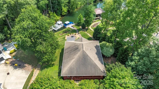 a aerial view of a house with a yard basket ball court and outdoor seating