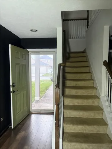 a view of entryway and hall with wooden floor