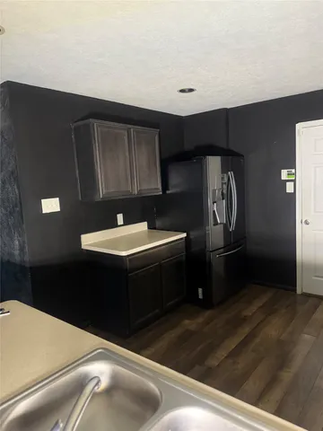 a kitchen with a sink and a refrigerator