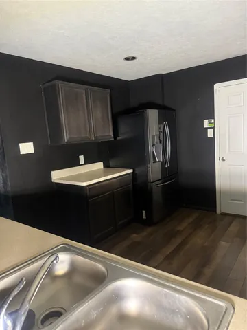 a kitchen with a sink and a refrigerator