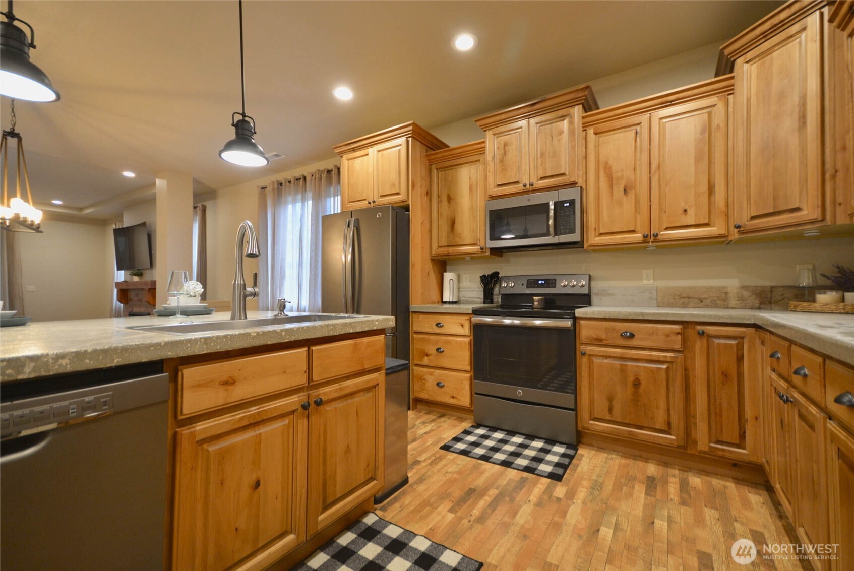 259 Parkside Loop Chehalis, WA 98532 - Photo 9 of 39 a kitchen with stainless steel appliances granite countertop a refrigerator a sink dishwasher a stove and white cabinets with wooden floor
