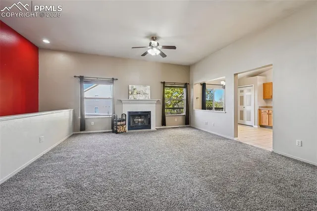 a view of a livingroom with an empty space and a fireplace