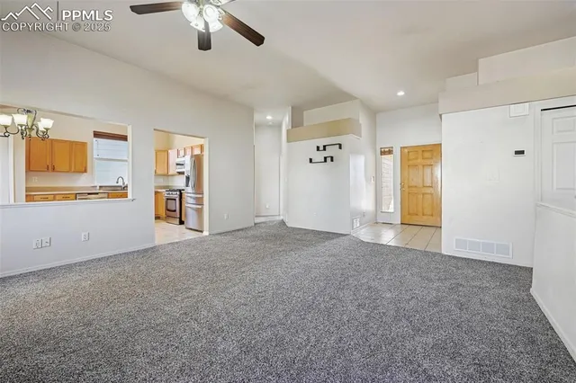 a view of a livingroom with an empty space and a window