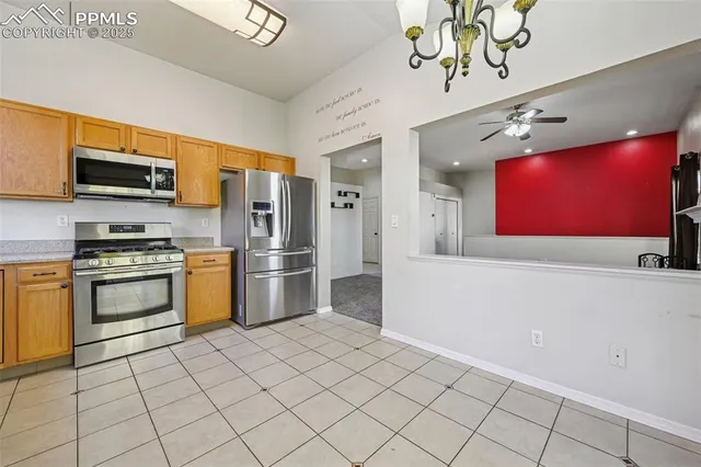a kitchen with stainless steel appliances a refrigerator and a stove top oven