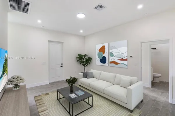 a living room with furniture and a rug