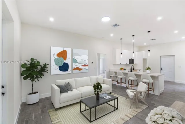 a living room with furniture and a potted plant