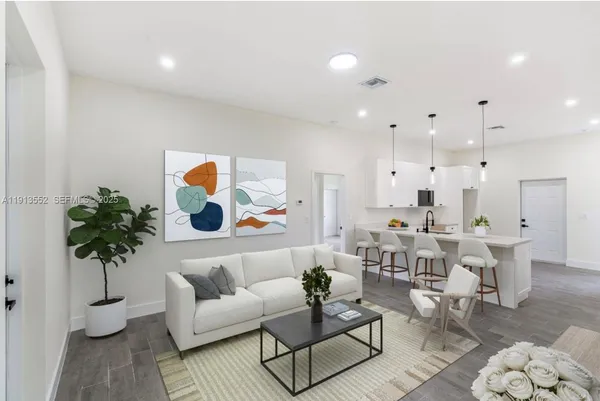 a living room with furniture and a potted plant