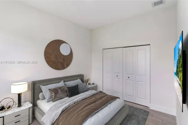 a bedroom with bed and a chandelier