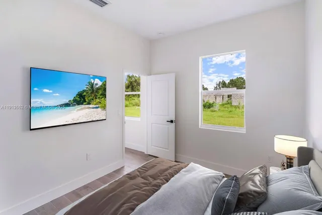 a bedroom with bed and window