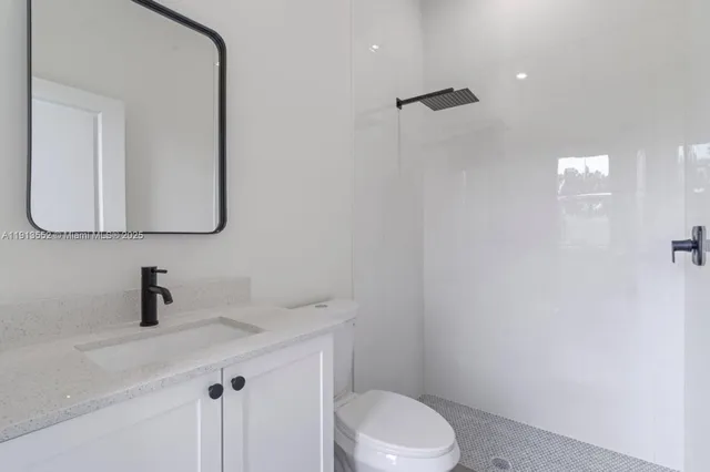 a bathroom with a sink a toilet and mirror