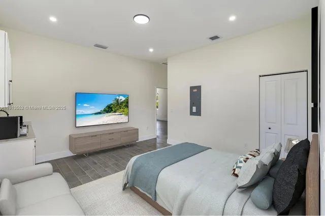 a bedroom with a bed and a couch