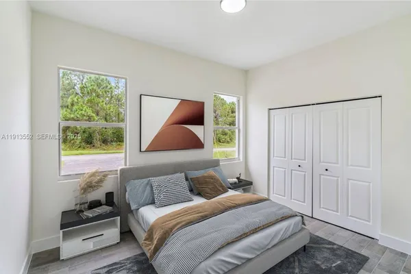 a bedroom with a bed and a window