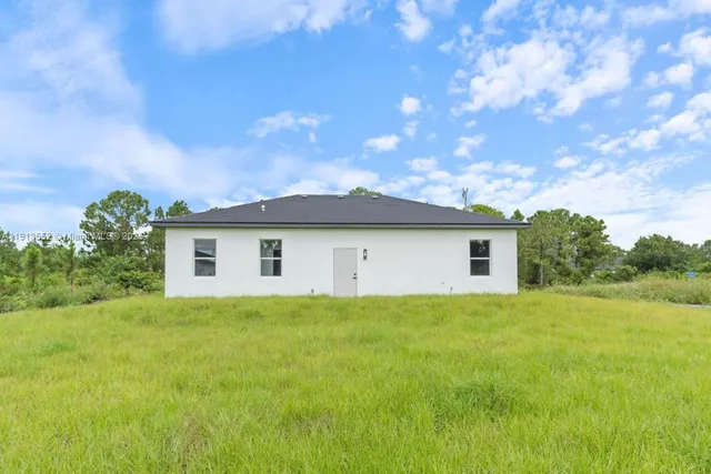 a front view of house with yard and trees
