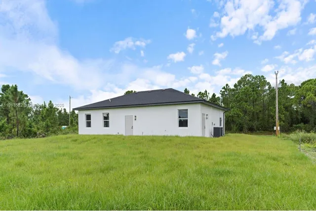a view of a house with yard and a garden