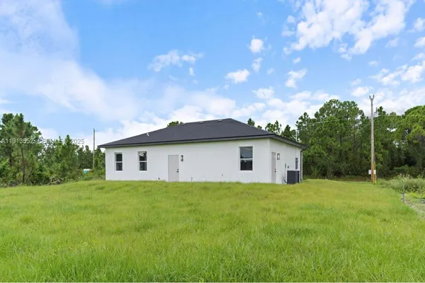 a view of a house with yard and a garden