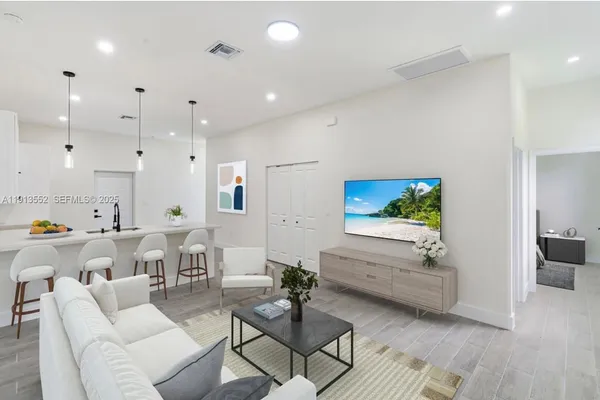 a living room with furniture and a wooden floor