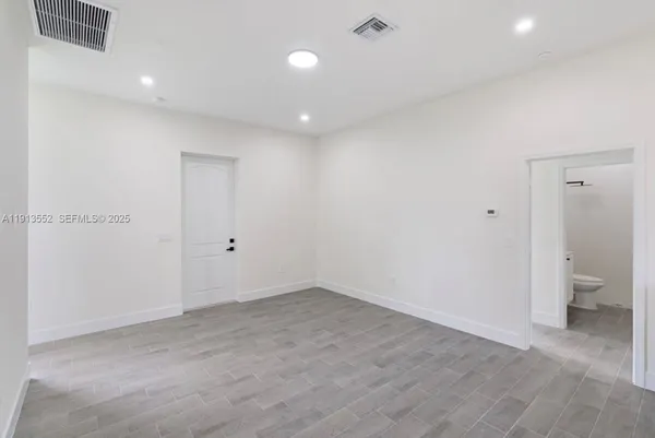 a view of an empty room with a bathroom