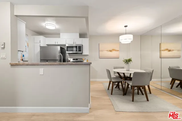 a view of kitchen with furniture and wooden floor