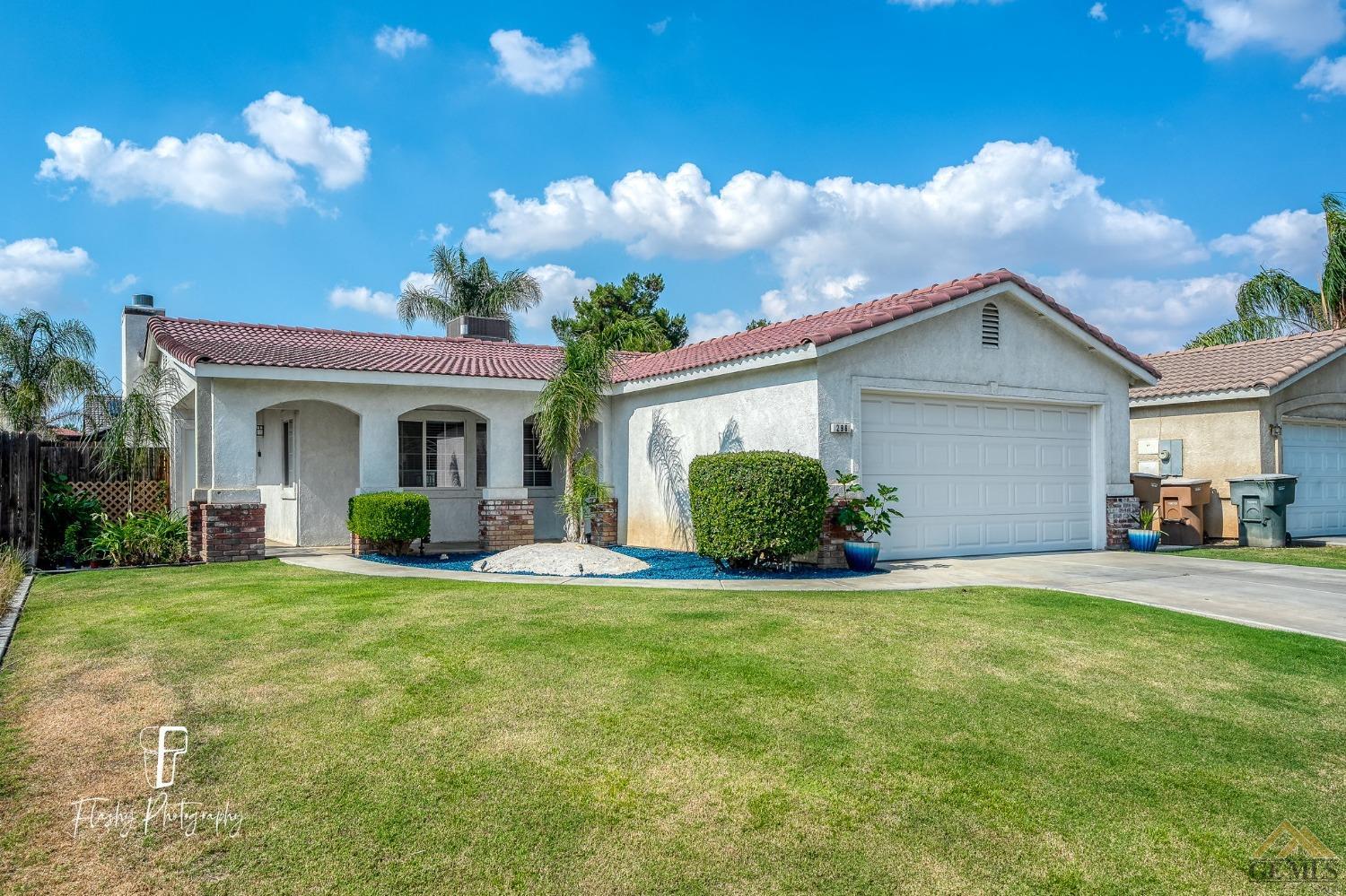 a view of a house with a yard and porch