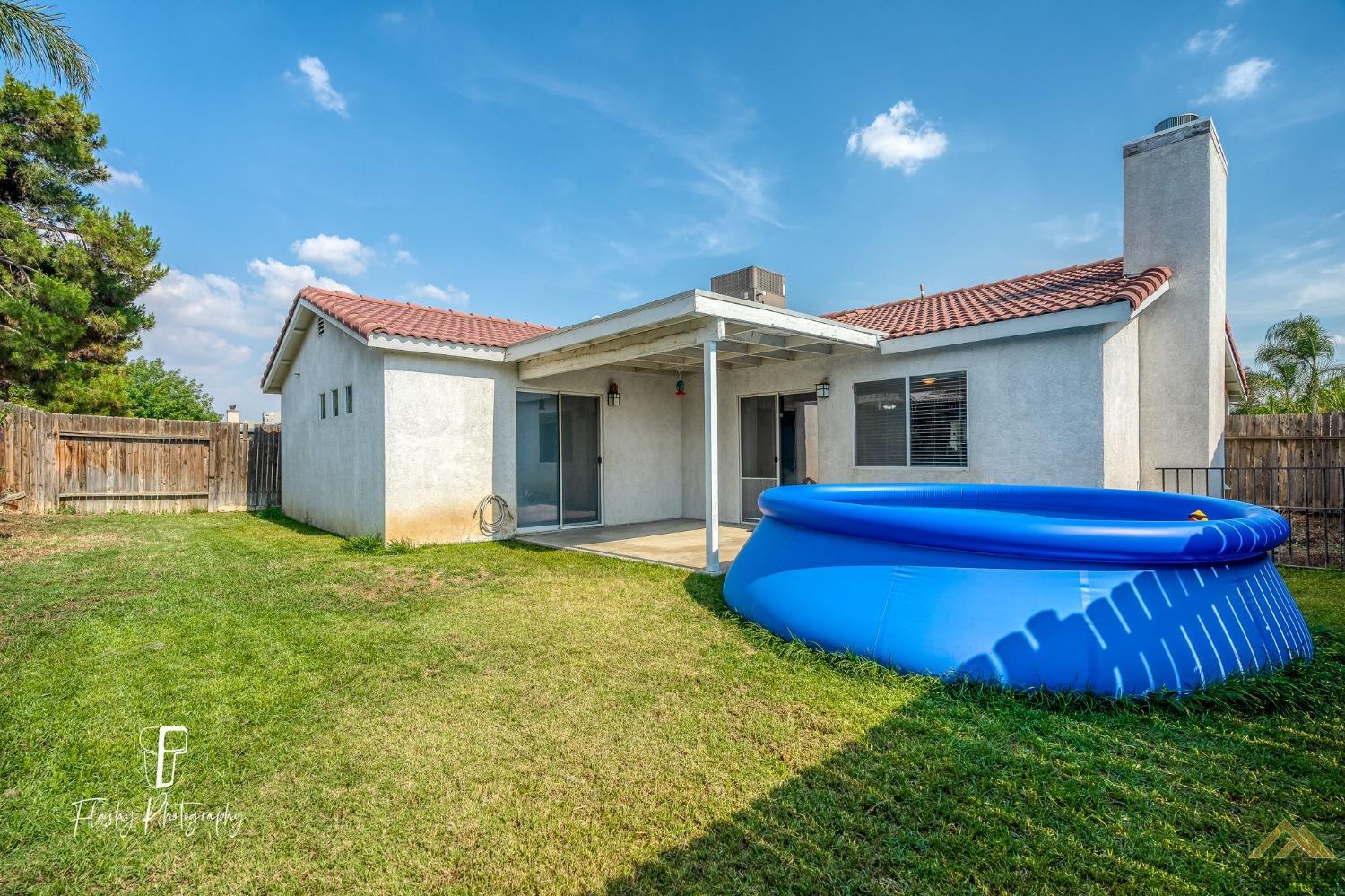 Undisclosed Address Bakersfield, CA 93308 - Photo 18 of 21 a view of a house with a backyard
