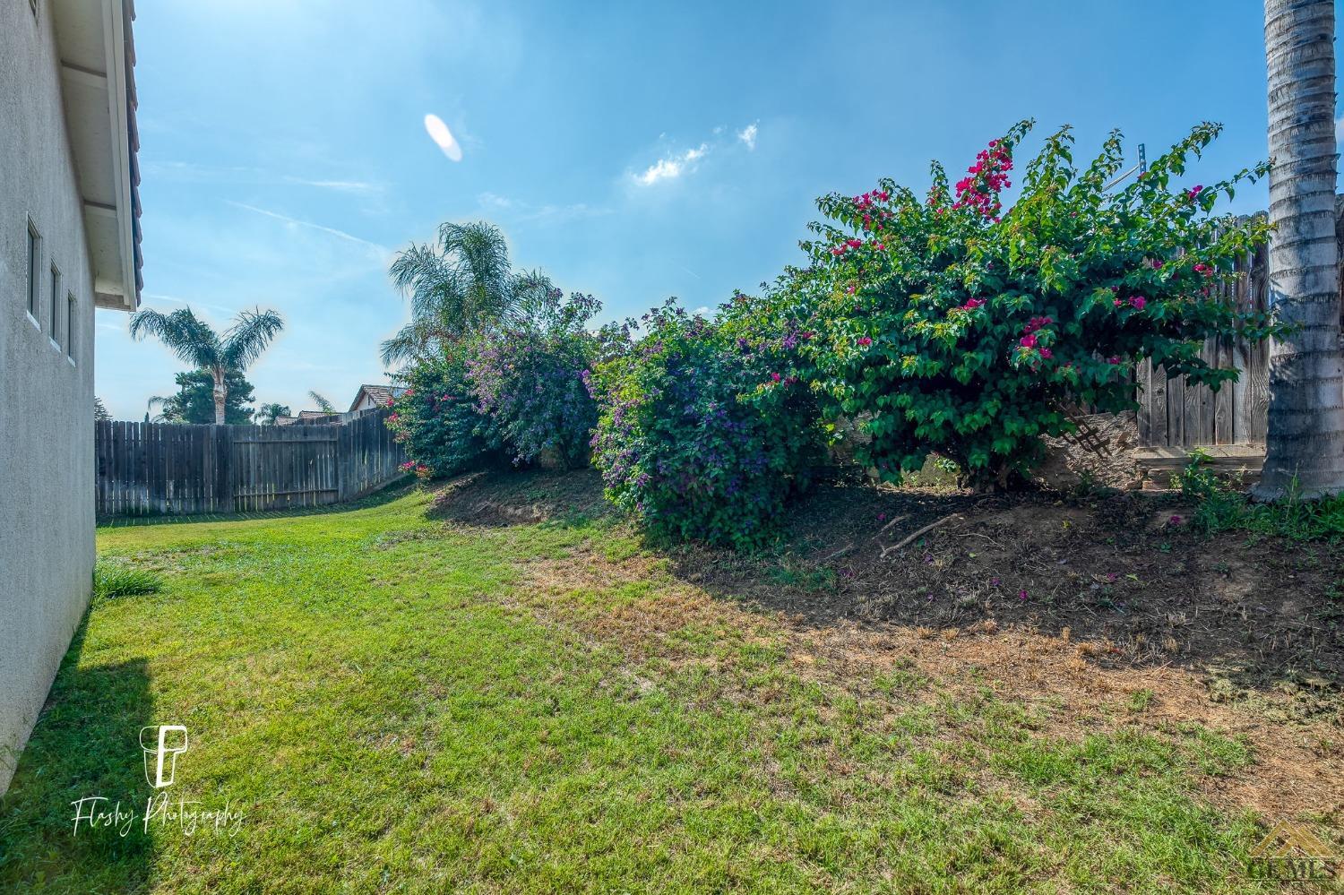 Undisclosed Address Bakersfield, CA 93308 - Photo 19 of 21 a backyard of a house with lots of green space