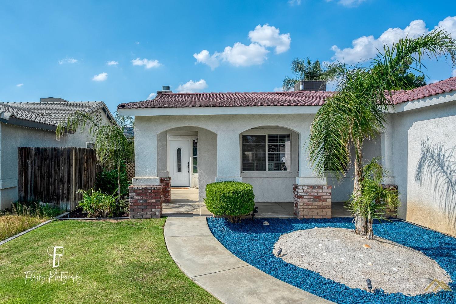 Undisclosed Address Bakersfield, CA 93308 - Photo 2 of 21 a view of a house with a yard fire pit and potted plants