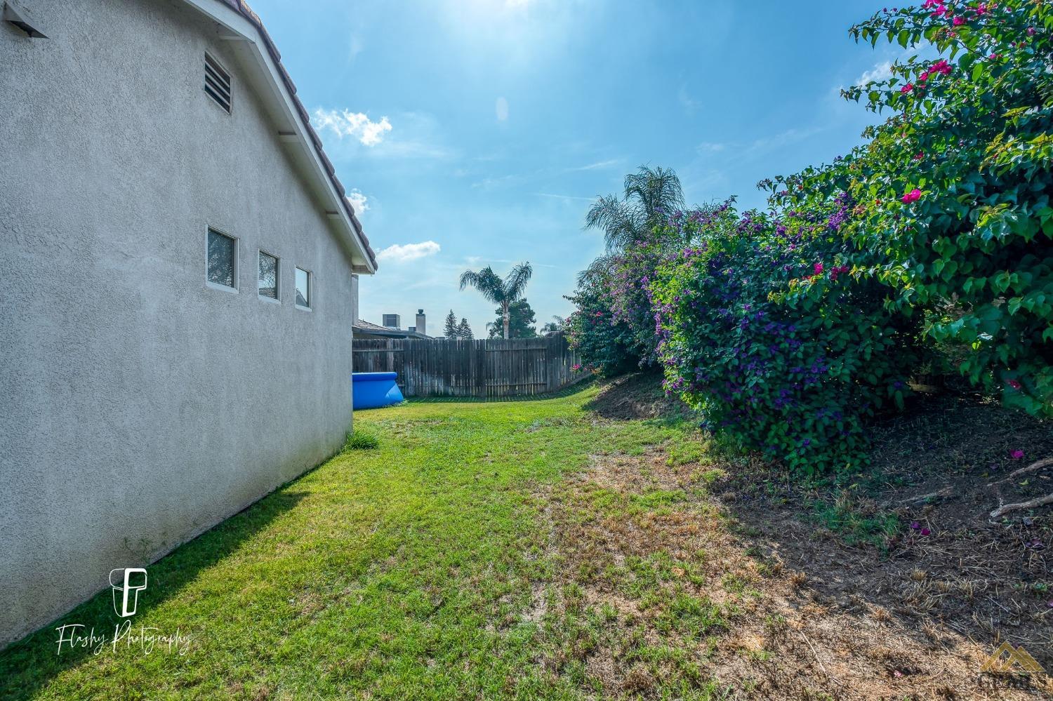 Undisclosed Address Bakersfield, CA 93308 - Photo 21 of 21 a backyard of a house with lots of green space