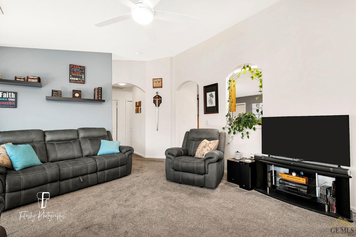 Undisclosed Address Bakersfield, CA 93308 - Photo 5 of 21 a living room with furniture and a flat screen tv