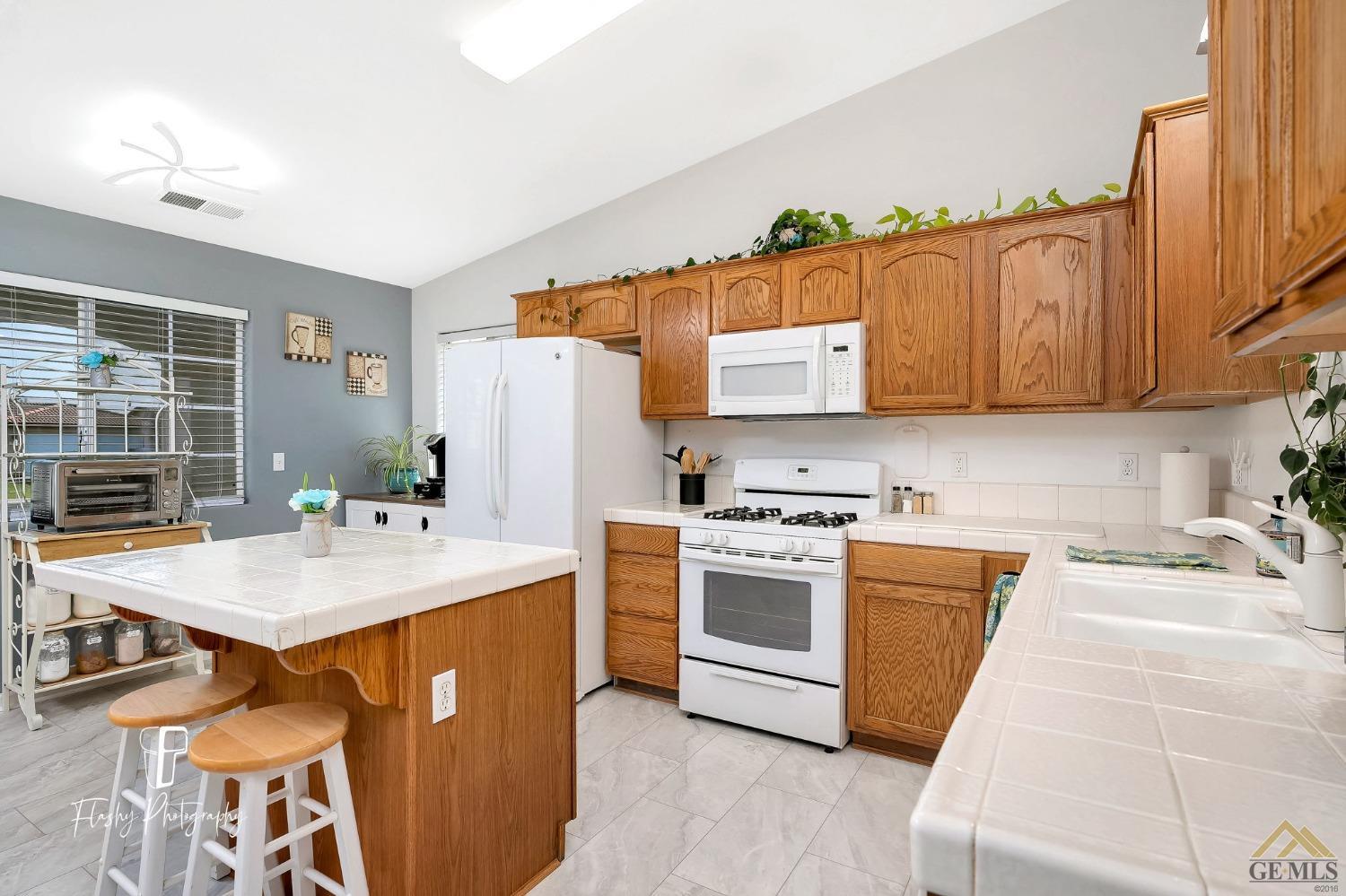 Undisclosed Address Bakersfield, CA 93308 - Photo 6 of 21 a kitchen with stainless steel appliances granite countertop a sink stove and refrigerator