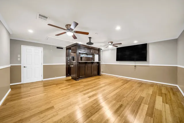 a view of a kitchen with a flat screen tv and refrigerator