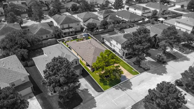 an aerial view of a house with a yard