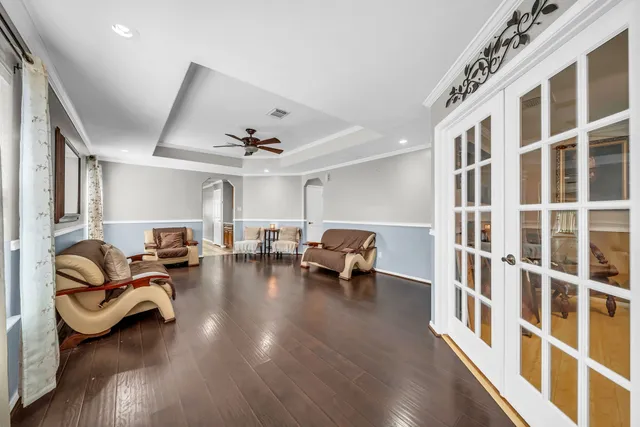 a living room with furniture and a chandelier