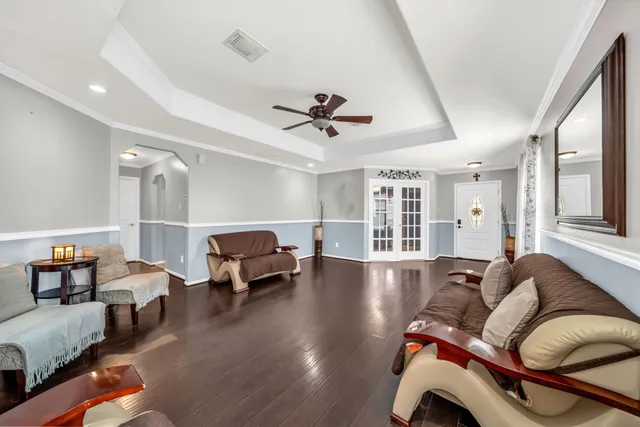 a living room with furniture and wooden floor