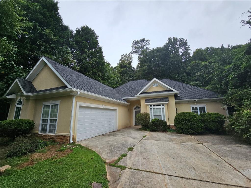 2167 Beecher Road Southwest Atlanta, GA 30311 - Photo 1 of 1 a front view of a house with a yard and trees