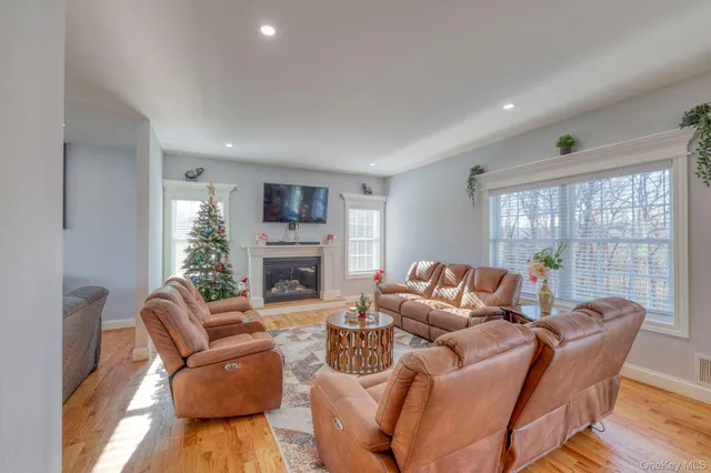 a living room with furniture a large window and a fireplace