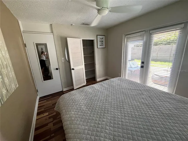 a bedroom with a bed and a large window
